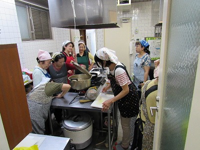 「厨房にて調理をされる西京地区更生保護女性会の皆さん」